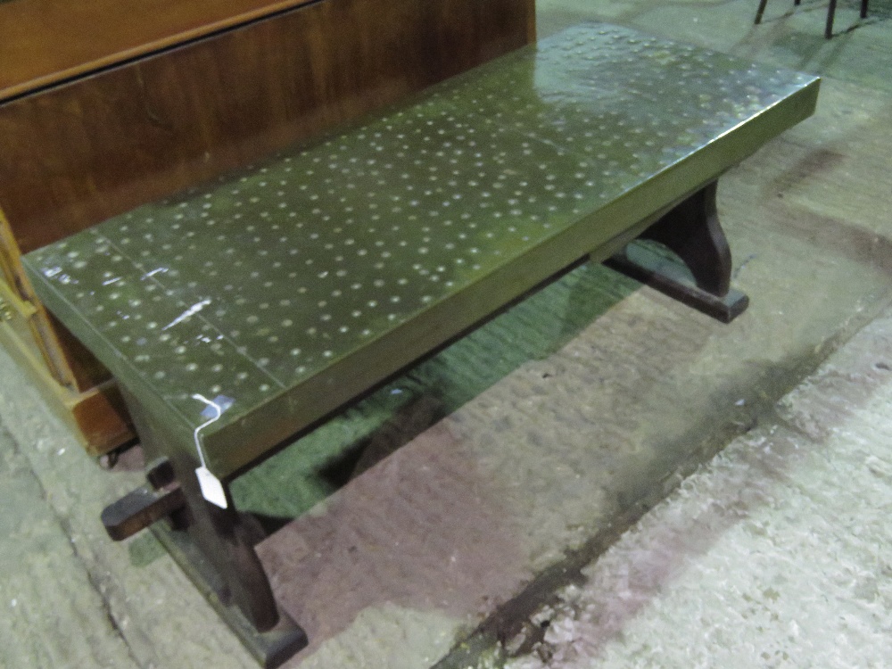 A hammered copper trellis coffee table,