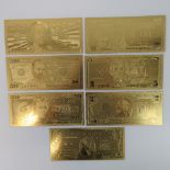 A set of 24ct gold plated American bank notes being 100, 50, 20, 10, 5, 2 and 1 US dollars.