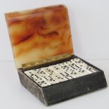 A stylish Deco period cased domino set of stylised form with angular agate style lid.
