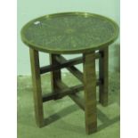 A 20th century tinned brass tray table raised over X-shaped base.