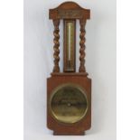 An Edwardian oak aneroid barometer with thermometer over marked for Stanley Latimer of Loughborough,