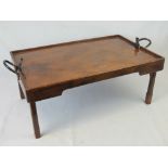 An unusual Edwardian mahogany metamorphic breakfast tray having twin mechanisms to release and