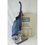 A vintage c1980s Kirby 'tradition' vacuum cleaner complete with boxed tool set.