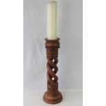 An oversized open twist wooden candlestick complete with candle, 53cm high.