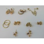 Nine pairs of 9ct gold and yellow metal earrings including hoops, studs and drop earrings.