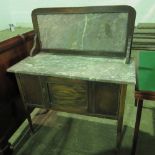 An Edwardian marble topped washstand with matching splashback and single cupboard under, 91cm wide.