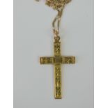 A 9ct gold cross having engraved pattern upon, stamped 9ct,