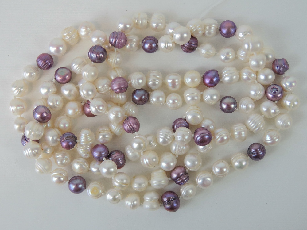 A long strand of baroque pearls, lilac and white hues,