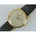 A 9ct gold vintage Omega wristwatch having 520 Cal movement, silvered dial with yellow metal hands,