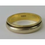 A white and yellow metal ring having single and triple Arabic hallmark, size S, 6g.