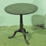 A late Georgian mahogany circular tilt top table raised over tripod base, 69cm dia.