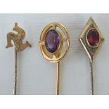 Three yellow metal tie pins, one of diamond form set with large oval pink stone,
