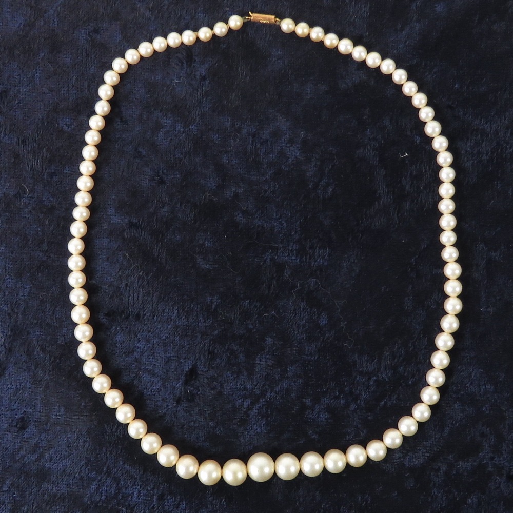 A string of graduated faux pearls having 9ct gold clasp stamped Ciro and 9ct,