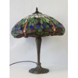 A Tiffany style leaded light table lamp with dragonfly decoration to the shade and tapered stand