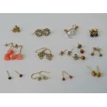 Thirteen pairs of 9ct gold and yellow metal earrings including; studs, drops,