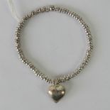 A HM silver bead Links of London style stretch bracelet having heart charm upon, hallmarked 925.