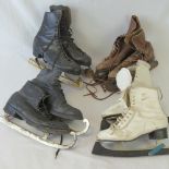 Four pairs of vintage ice-skates.