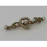 A 15ct gold and diamond brooch having floral and heart design encrusted with seed pearls,