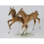 A German made ceramic prancing foals figurine by Lorenz Hutschenreuther, standing 22cm high.