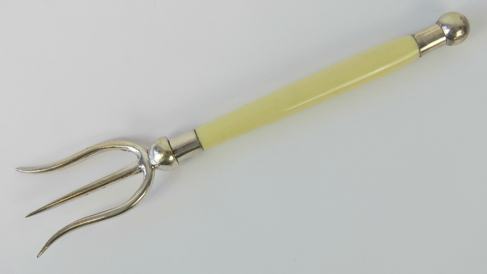 A HM silver toast fork with ivorine handle, hallmarked Sheffield 1911-12, 23cm in length.