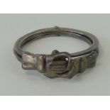 An unusual ring comprising three hinged bands when closed forming two clasped hands and when open