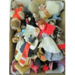 A quantity of assorted wooden and plasticised dolls in national dress.