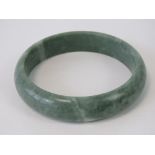 An opaque moss green jade bangle, approx 6.2cm internal dia, approx 7.7cm external dia, 49.6g.