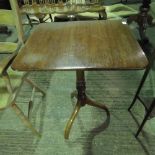 A late Georgian square tilt top table rasied over turned stem over three outswept feet,