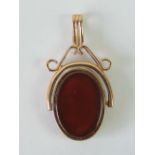 A bloodstone and carnelian spinning double sided fob/pendant in rose metal, 3.3cm in length.