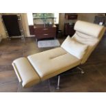 A cream leather contemporary full length relaxation chair with matching loose cushion,