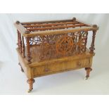 A fine quality 19th century walnut Canterbury having three upper sections flanked by pierced and