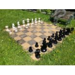 A full set of exterior ceramic chess pieces, tallest 40cm high.