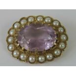 A 9ct gold amethyst and pearl brooch, central oval mixed cut amethyst (1.5 x 1.