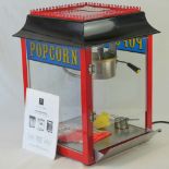 A Paragon professional popcorn machine, model number 1911-4oz popper, and popcorn boxes.