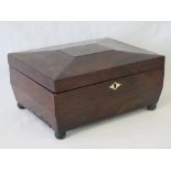 A Victorian walnut sarcophagus shaped workbox, lid lifting to reveal compartment within,