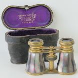 A pair of late 19thC German opera glasses, signed Overhage, Elberfeld, in fitted leather case.