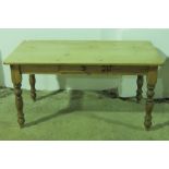 A good contemporary pine kitchen table raised over turned legs and single drawer, 148 x 81cm.