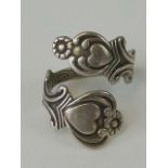 A silver wrap around style ring with heart and scrollwork design, stamped 925 Sterling silver,