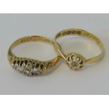 Two 18ct gold and diamond rings; one with central diamond in floral shaped head, size L,