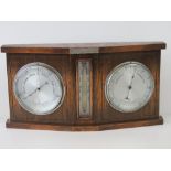 A c1930s stained oak aneroid thermometer barometer complete with storm glass.