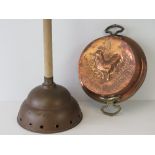 An embossed copper and brass two handled dish depicting a cockerel upon,