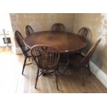 A good circular oak table raised over turned stem upon three outswept legs.