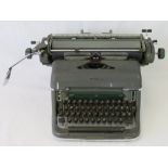 A mid 20thC Olympia De luxe typewriter in grey and green livery.