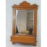 A smart honeyed oak Victorian bevel edged wall mounted hall mirror with brush box under,