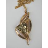An abstract 9ct gold and citrine pendant on yellow metal chain, pendant measuring 5.
