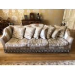 A very large three seater Knoll type sofa having shaped back and sides,
