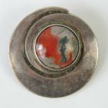A Scottish HM silver brooch of circular swirling form with central agate cabachon,
