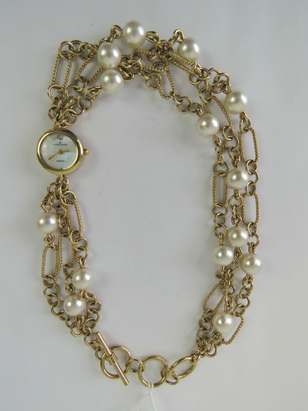 An Anne Klein double wrap bracelet watch having mother of pearl dial.