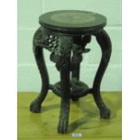 A carved and pierced short planted stand with inset marble top,