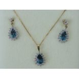 A suite of topaz jewellery comprising pendant on 9ct gold fine chain and matching drop earrings.